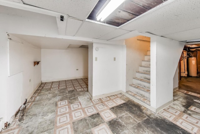 7649 S Dobson Ave, Chicago, IL 60619 - finished basement with gas water heater, stairs, and tile patterned floors