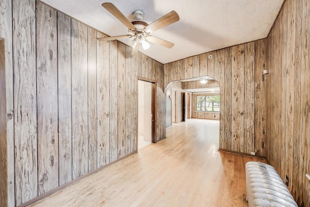 7649 S Dobson Ave, Chicago, IL 60619 - hallway with wood walls, radiator, wood finished floors, and a textured ceiling
