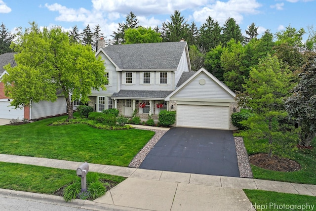 1116 Stonegate Ct, Bartlett, IL 60103 - traditional-style home with an attached garage, a front yard, driveway, a shingled roof, and a chimney