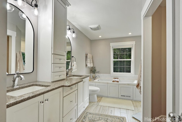 1116 Stonegate Ct, Bartlett, IL 60103 - bathroom with healthy amount of natural light, toilet, double vanity, a bath, and recessed lighting