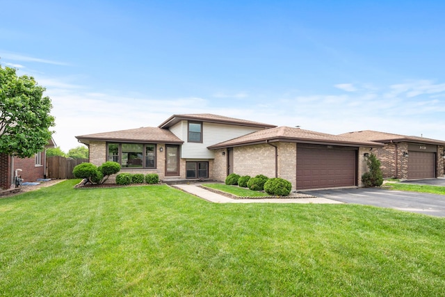 9031 170th St, Orland Hills, IL 60487 - tri-level home with brick siding, asphalt driveway, and a garage