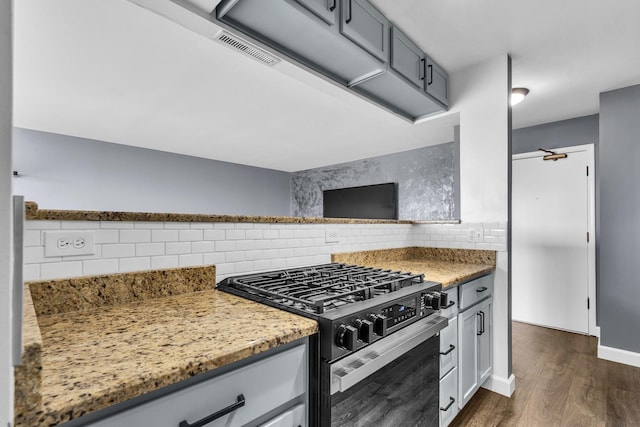 850 Wellington Ave Unit 515, Elk Grove Village, IL 60007 - kitchen featuring gas stove, tasteful backsplash, dark wood-style flooring, light stone counters, and baseboards