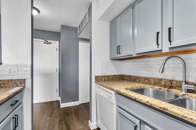 850 Wellington Ave Unit 515, Elk Grove Village, IL 60007 - kitchen featuring dishwasher, a sink, dark wood-type flooring, decorative backsplash, and light stone counters