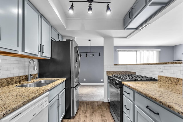 850 Wellington Ave Unit 515, Elk Grove Village, IL 60007 - kitchen featuring black range with gas cooktop, white dishwasher, a sink, wood finished floors, and tasteful backsplash
