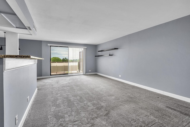 850 Wellington Ave Unit 515, Elk Grove Village, IL 60007 - unfurnished living room featuring baseboards, carpet floors, and a dry bar