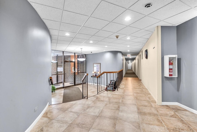 850 Wellington Ave Unit 515, Elk Grove Village, IL 60007 - corridor featuring an upstairs landing, baseboards, recessed lighting, and a paneled ceiling