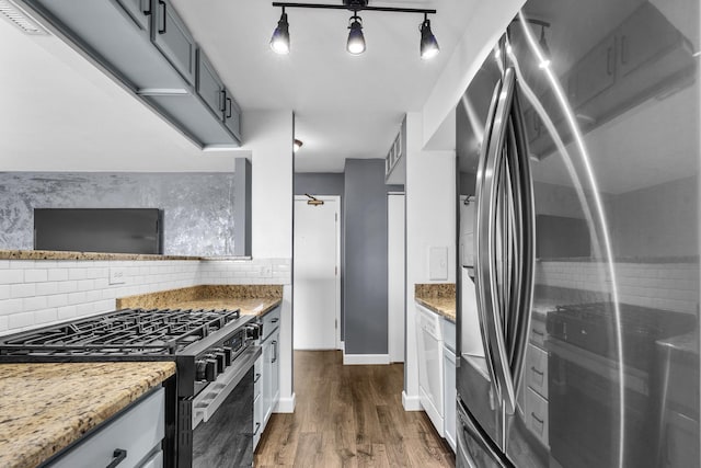 850 Wellington Ave Unit 515, Elk Grove Village, IL 60007 - kitchen featuring appliances with stainless steel finishes, dark wood finished floors, tasteful backsplash, baseboards, and light stone countertops