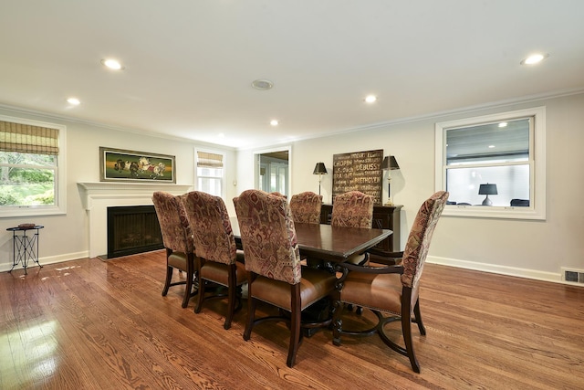 110 Inverway, Inverness, IL 60067 - dining area with ornamental molding, wood finished floors, recessed lighting, a fireplace with flush hearth, and baseboards
