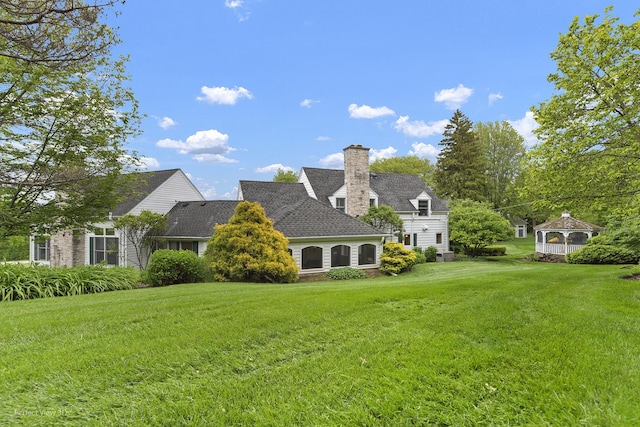 110 Inverway, Inverness, IL 60067 - rear view of house featuring a lawn, a chimney, and a gazebo