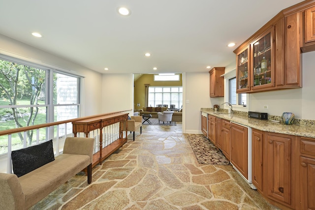 110 Inverway, Inverness, IL 60067 - kitchen with stone flooring, recessed lighting, plenty of natural light, light stone countertops, and brown cabinets