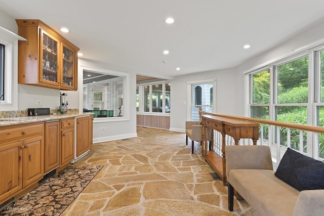 110 Inverway, Inverness, IL 60067 - kitchen featuring stone floors, baseboards, recessed lighting, glass insert cabinets, and light stone countertops