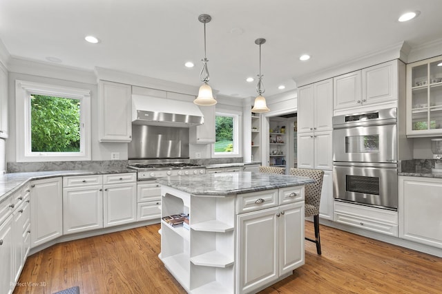 110 Inverway, Inverness, IL 60067 - kitchen with open shelves, double oven, wall chimney range hood, ornamental molding, and white cabinets