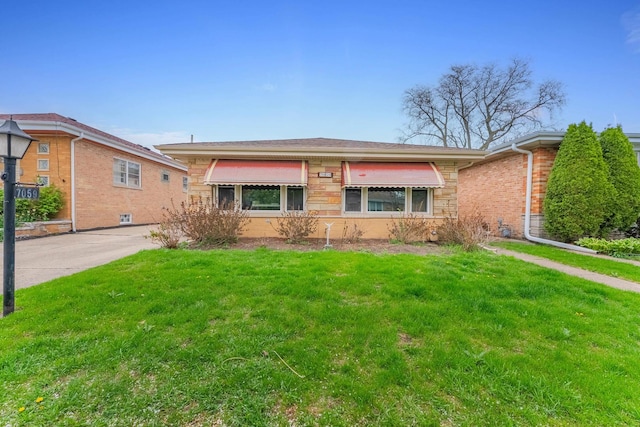 7059 N Ottawa Ave, Chicago, IL 60631 - view of front facade featuring a front yard and brick siding