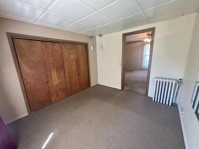 418 Starr St, Belvidere, IL 61008 - unfurnished bedroom featuring radiator heating unit, carpet flooring, a closet, and baseboards
