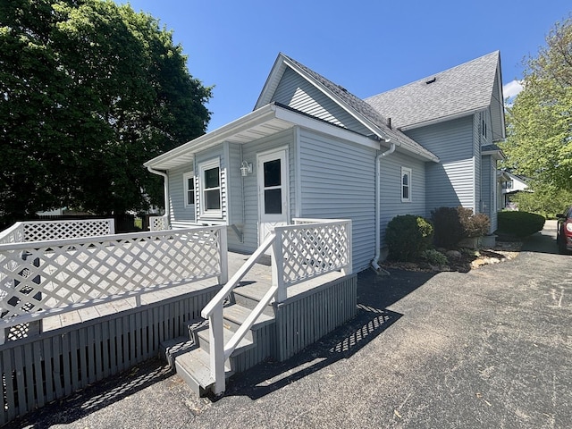 418 Starr St, Belvidere, IL 61008 - view of side of property with a shingled roof and a deck