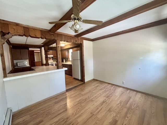 418 Starr St, Belvidere, IL 61008 - kitchen with white appliances, a baseboard radiator, tile counters, beamed ceiling, and light wood-style flooring