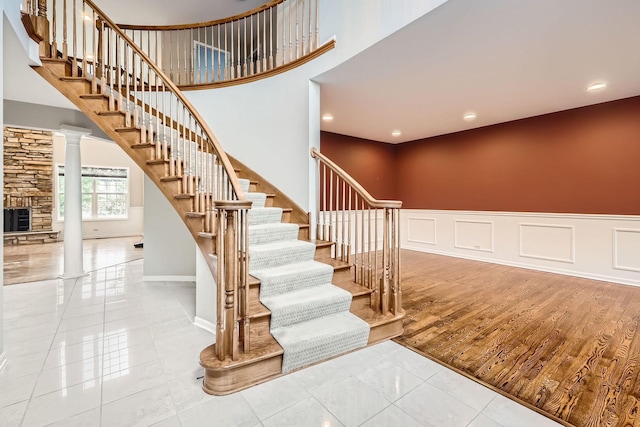 830 W Lukas Ave, Palatine, IL 60067 - staircase featuring decorative columns, a high ceiling, recessed lighting, a wainscoted wall, and baseboards