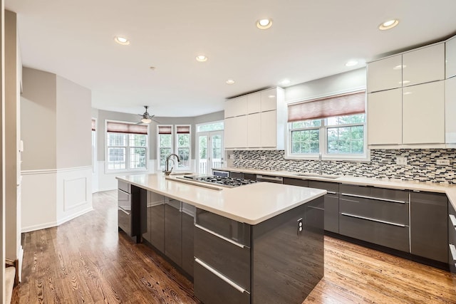 830 W Lukas Ave, Palatine, IL 60067 - kitchen featuring modern cabinets, a sink, a wainscoted wall, light countertops, and light wood finished floors
