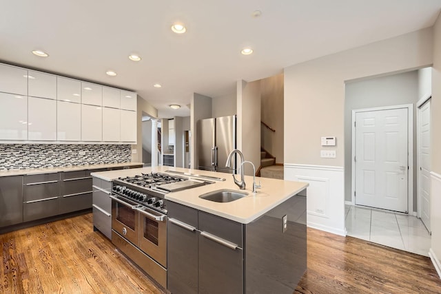 830 W Lukas Ave, Palatine, IL 60067 - kitchen with stainless steel appliances, modern cabinets, white cabinets, a sink, and a center island with sink