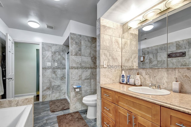12599 S Archer Ave, Lemont, IL 60439 - bathroom with tile walls, vanity, toilet, a garden tub, and a tile shower