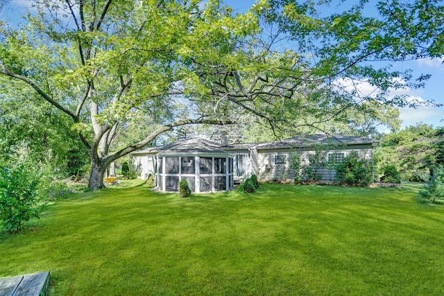 12599 S Archer Ave, Lemont, IL 60439 - rear view of house featuring a sunroom and a lawn