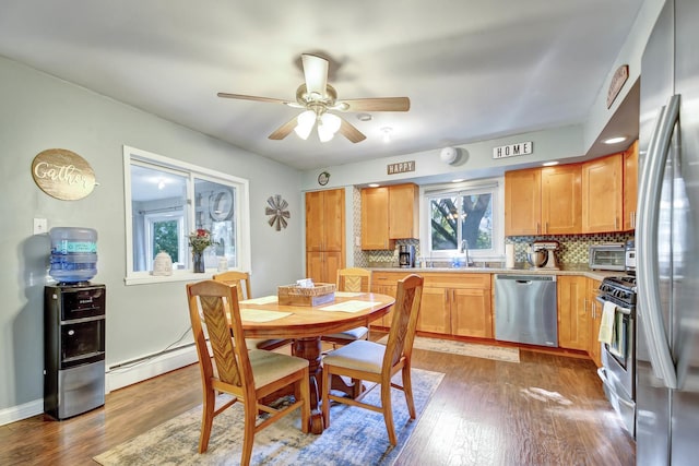 12599 S Archer Ave, Lemont, IL 60439 - dining area with wood finished floors, a ceiling fan, and a baseboard heating unit
