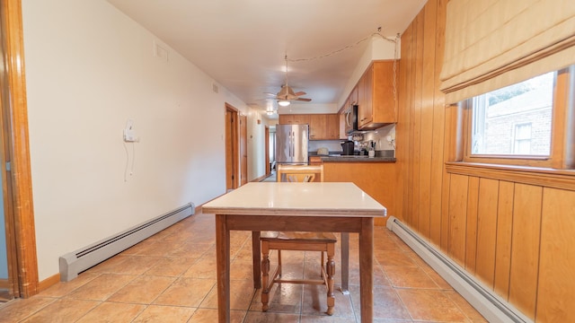 13122 S Escanaba Ave, Chicago, IL 60633 - kitchen with baseboard heating, a baseboard heating unit, stainless steel appliances, brown cabinets, and light tile patterned flooring