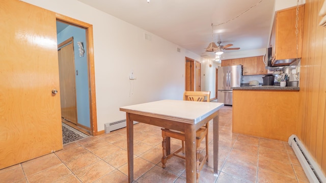 13122 S Escanaba Ave, Chicago, IL 60633 - kitchen featuring baseboard heating, stainless steel appliances, a ceiling fan, a baseboard heating unit, and dark countertops