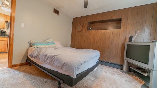 13122 S Escanaba Ave, Chicago, IL 60633 - bedroom with wood walls, light colored carpet, and a ceiling fan