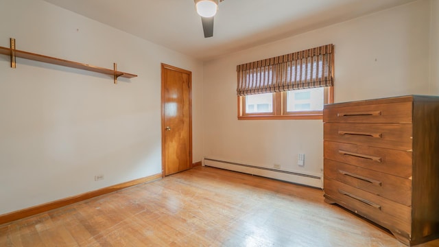 13122 S Escanaba Ave, Chicago, IL 60633 - unfurnished bedroom featuring a baseboard heating unit, light wood-style floors, ceiling fan, and baseboards