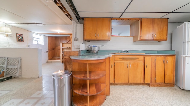 13122 S Escanaba Ave, Chicago, IL 60633 - kitchen featuring freestanding refrigerator, light flooring, a sink, brown cabinetry, and light countertops