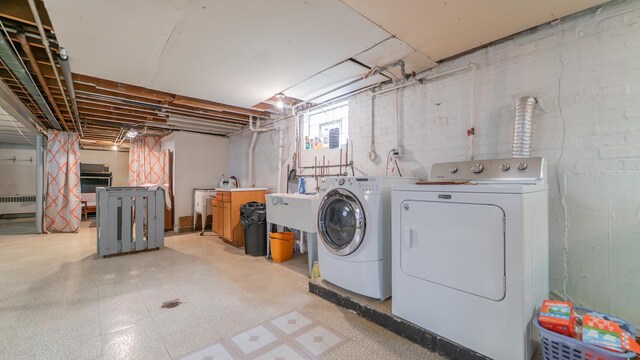 13122 S Escanaba Ave, Chicago, IL 60633 - washroom with separate washer and dryer, light flooring, and radiator heating unit