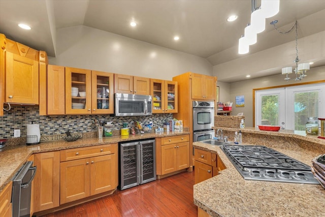 318 W Market St, Farmer City, IL 61842 - kitchen featuring beverage cooler, stainless steel appliances, vaulted ceiling, wood finished floors, and backsplash