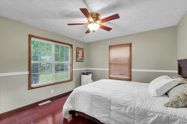 318 W Market St, Farmer City, IL 61842 - bedroom with wood finished floors, ceiling fan, a textured ceiling, and baseboards