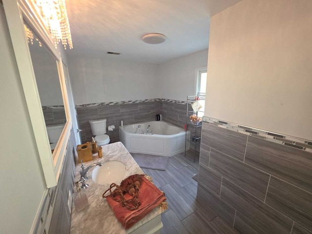 105 Marquette St, Park Forest, IL 60466 - full bathroom with tile walls, a bath, vanity, a wainscoted wall, and a chandelier