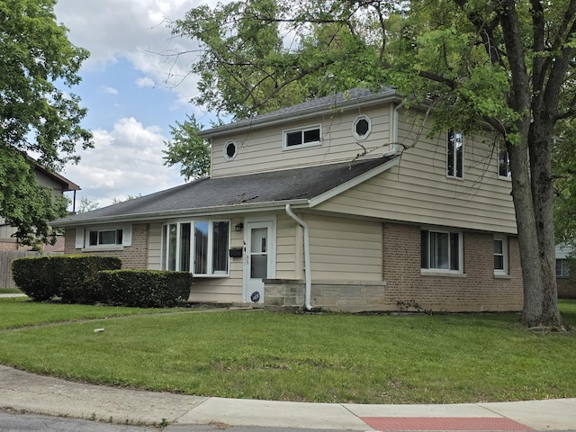 105 Marquette St, Park Forest, IL 60466 - traditional-style home featuring a front lawn, brick siding, and roof with shingles