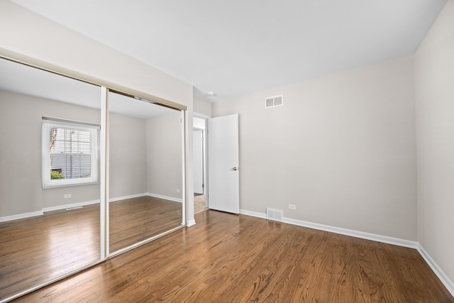 4435 Black Partridge Ln, Lisle, IL 60532 - unfurnished bedroom with wood finished floors, a closet, and baseboards