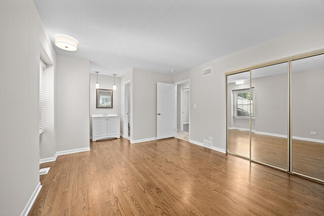 4435 Black Partridge Ln, Lisle, IL 60532 - unfurnished bedroom with wood finished floors, baseboards, and a closet