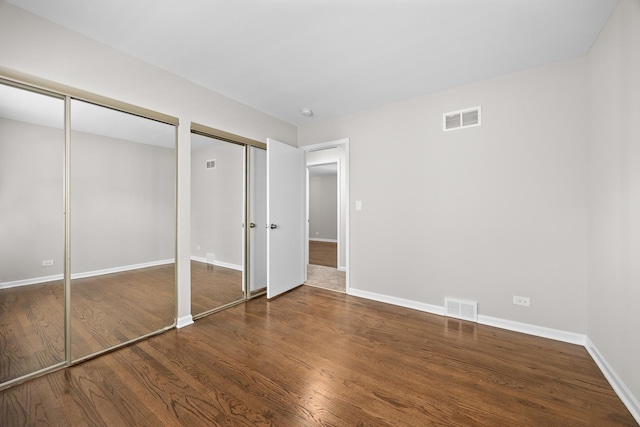 4435 Black Partridge Ln, Lisle, IL 60532 - unfurnished bedroom with two closets, wood finished floors, and baseboards