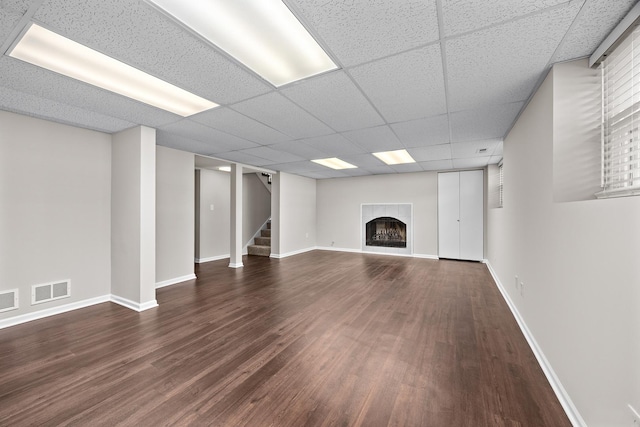 4435 Black Partridge Ln, Lisle, IL 60532 - unfurnished living room featuring dark wood finished floors, a fireplace, stairs, baseboards, and a paneled ceiling