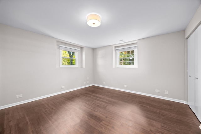 4435 Black Partridge Ln, Lisle, IL 60532 - unfurnished bedroom with dark wood-style floors, multiple windows, baseboards, and a closet