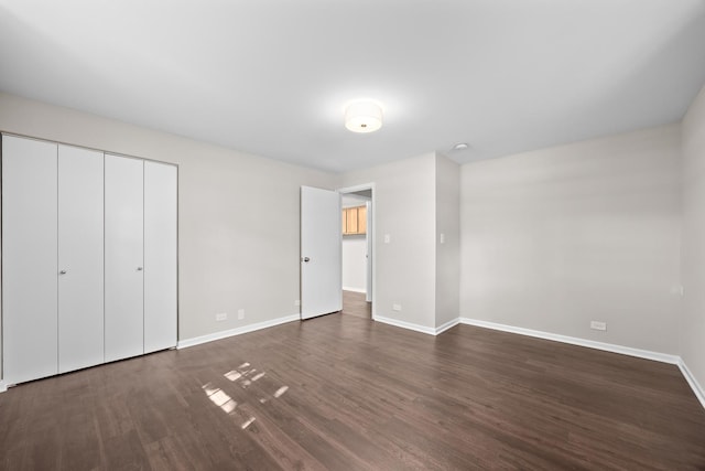 4435 Black Partridge Ln, Lisle, IL 60532 - unfurnished bedroom with baseboards, dark wood-style flooring, and a closet