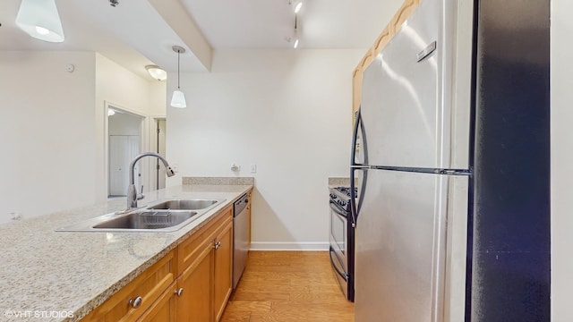 1400 S Michigan Ave Unit 1211, Chicago, IL 60605 - kitchen featuring stainless steel appliances, a sink, brown cabinets, light wood-type flooring, and pendant lighting