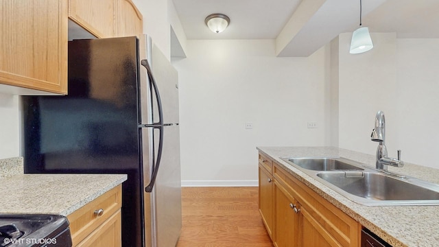1400 S Michigan Ave Unit 1211, Chicago, IL 60605 - kitchen with freestanding refrigerator, a sink, light wood-type flooring, light countertops, and baseboards