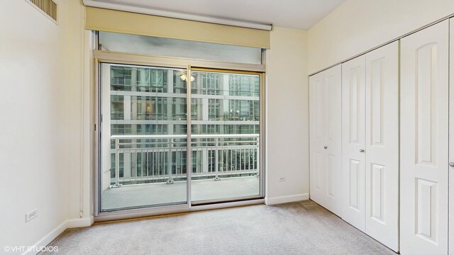 1400 S Michigan Ave Unit 1211, Chicago, IL 60605 - unfurnished bedroom featuring carpet floors, baseboards, a closet, and access to exterior