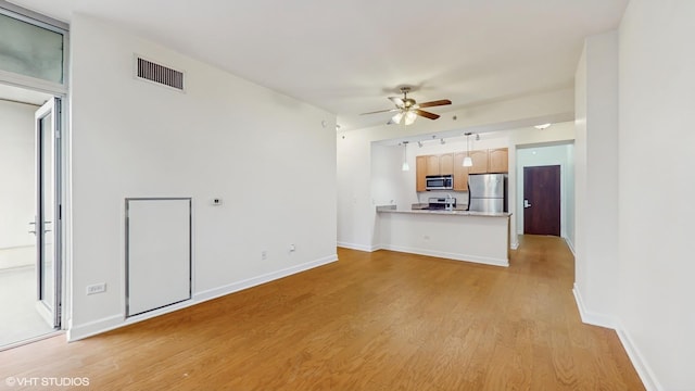 1400 S Michigan Ave Unit 1211, Chicago, IL 60605 - unfurnished living room featuring a ceiling fan, light wood-style flooring, and baseboards