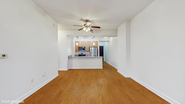 1400 S Michigan Ave Unit 1211, Chicago, IL 60605 - unfurnished living room featuring a ceiling fan, wood finished floors, and baseboards