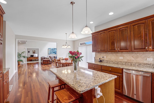 22665 Joshua Dr, Frankfort, IL 60423 - kitchen with stainless steel dishwasher, backsplash, dark wood-type flooring, a kitchen bar, and light stone counters