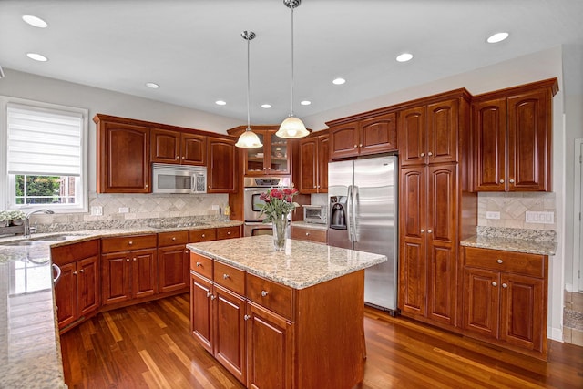22665 Joshua Dr, Frankfort, IL 60423 - kitchen with appliances with stainless steel finishes, dark wood finished floors, a sink, tasteful backsplash, and light stone counters