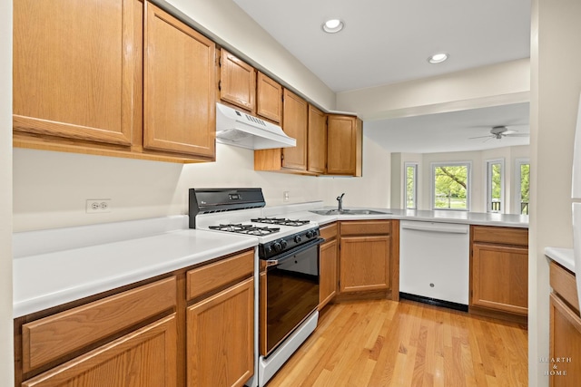358 Bristol Ln, Fox River Grove, IL 60021 - kitchen with white dishwasher, range with gas cooktop, under cabinet range hood, light countertops, and light wood-type flooring